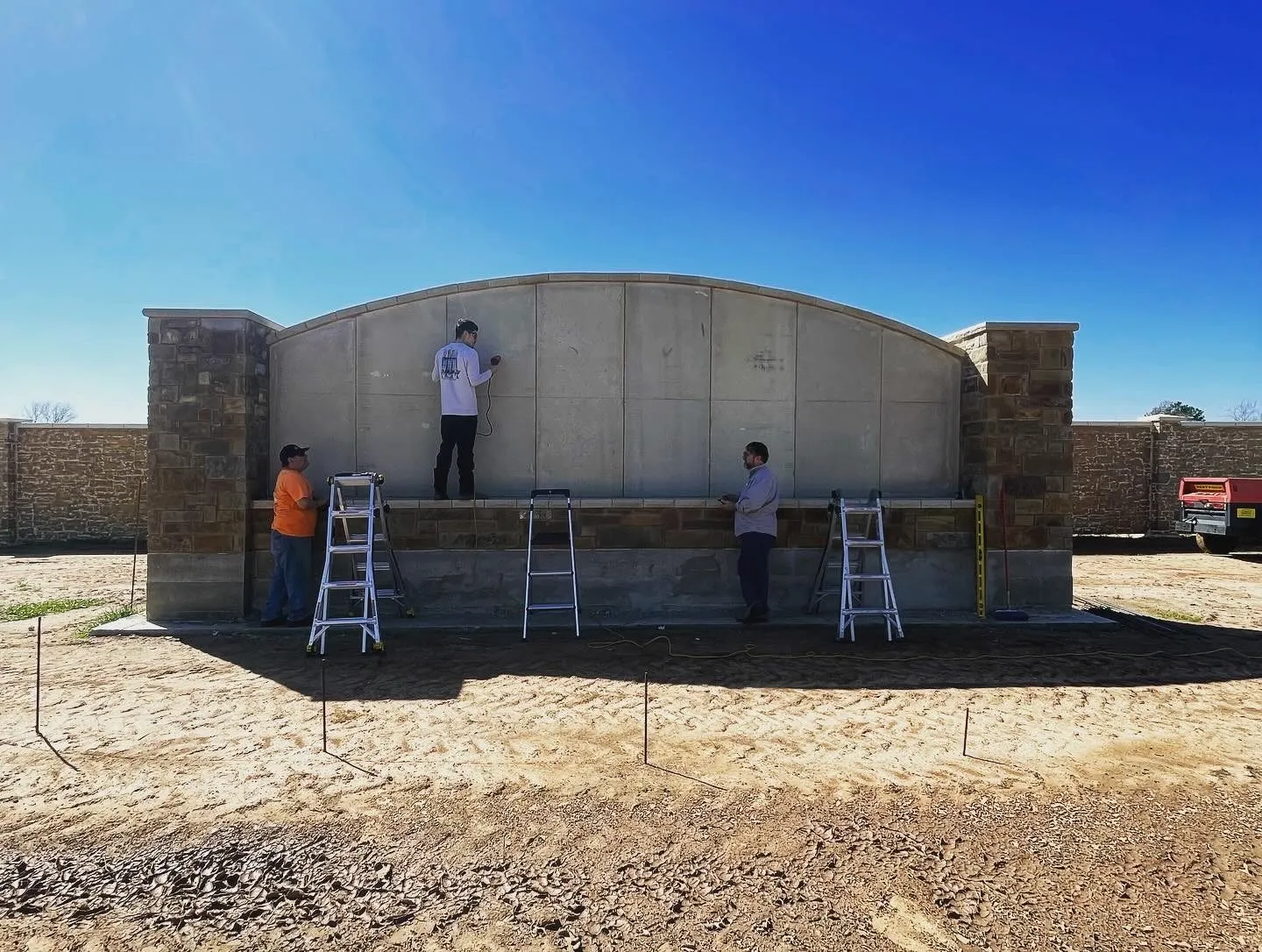 Crew restoring a stone entrance wall